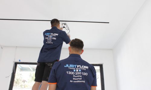 Justflow Electrician installing Black LED Linear Lights in white ceiling Sydney